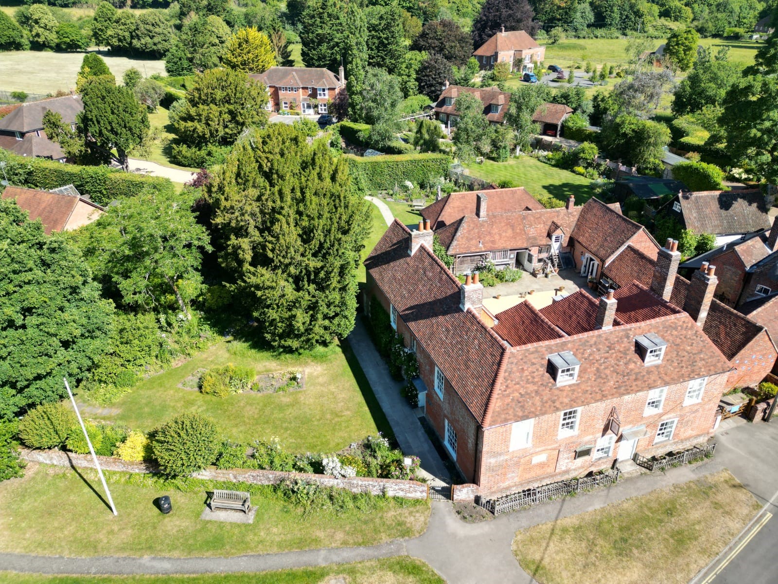 An aerial view of Jane Austen's House that shows the property in the context of it's location within trees