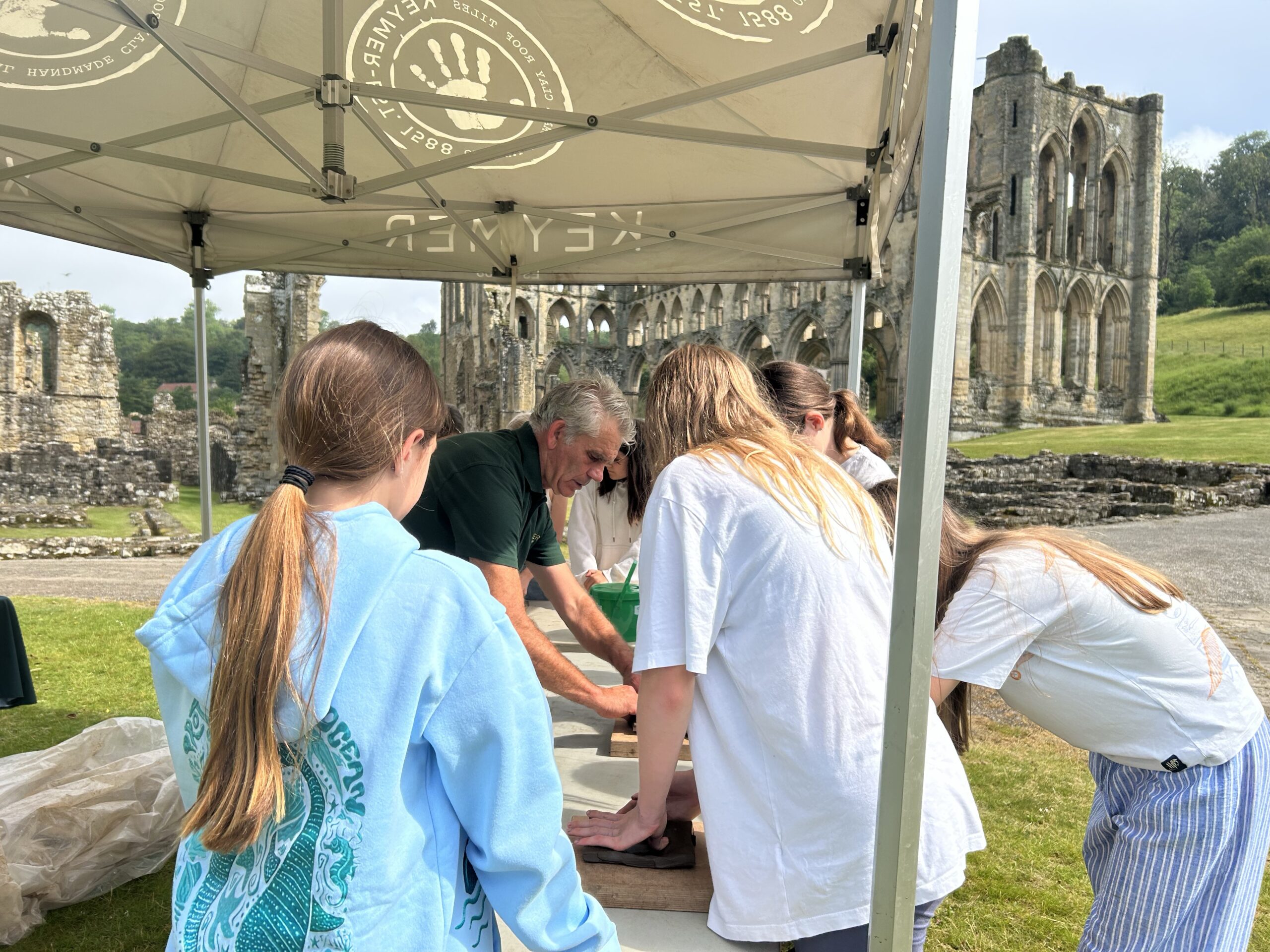 School children at Rievaulx Abbey participating in clay sculpting